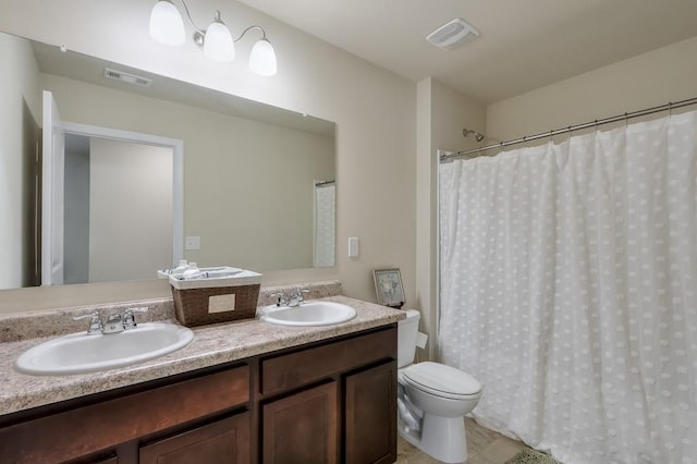 full bath featuring double vanity, visible vents, and a sink