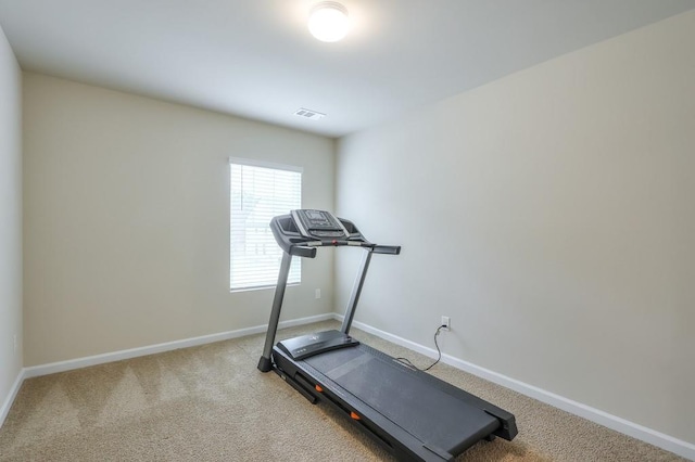 exercise area featuring carpet flooring, visible vents, and baseboards