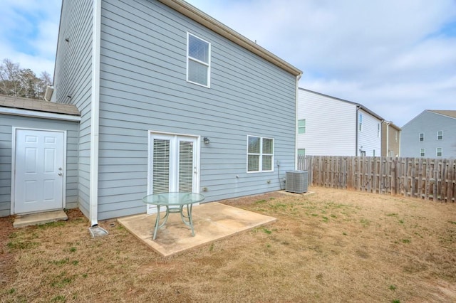 back of property with a patio, a yard, cooling unit, and fence