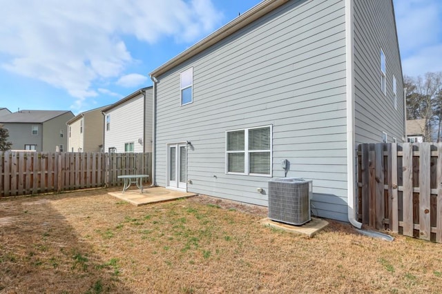 back of house with a yard, central AC unit, and a fenced backyard