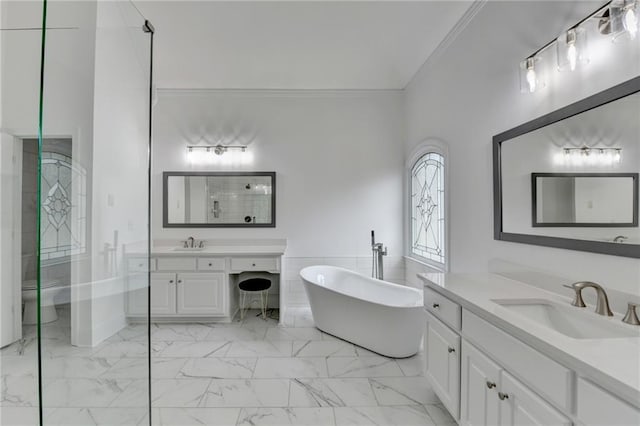 bathroom featuring vanity, a tub to relax in, ornamental molding, and toilet