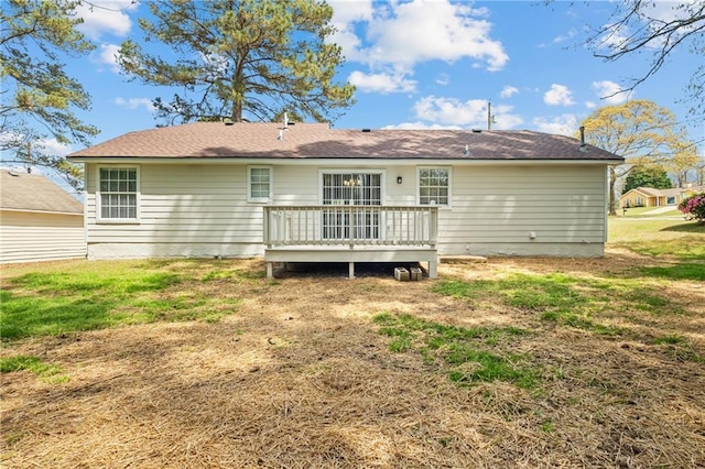 rear view of property with a yard and a wooden deck