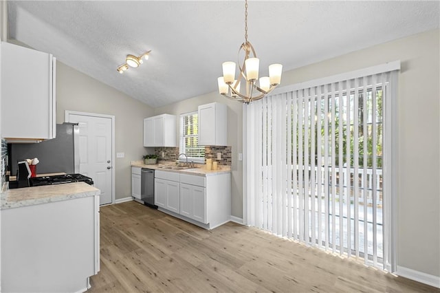 kitchen featuring white cabinetry, light countertops, light wood finished floors, and appliances with stainless steel finishes
