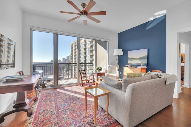 living room featuring ceiling fan and hardwood / wood-style flooring