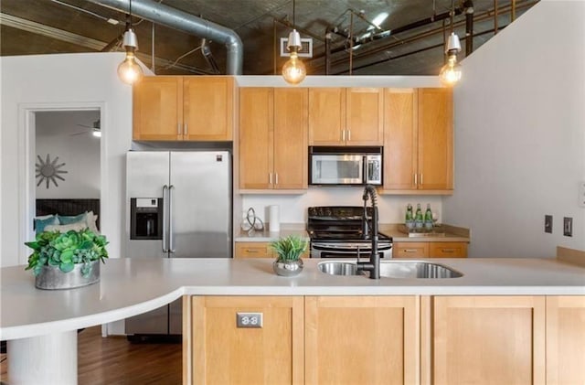 kitchen featuring light countertops, visible vents, light brown cabinetry, appliances with stainless steel finishes, and dark wood-type flooring