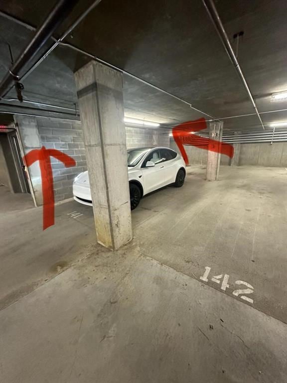 parking garage featuring concrete block wall