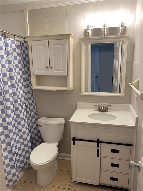 bathroom with tile patterned flooring, a shower with curtain, vanity, and toilet