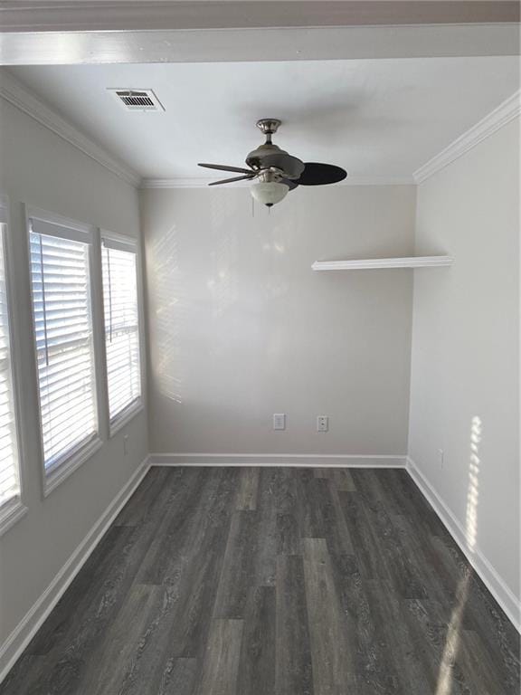 empty room featuring ceiling fan, crown molding, and dark wood-type flooring