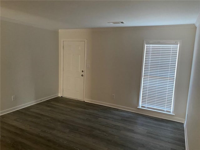 unfurnished room with ornamental molding and dark wood-type flooring