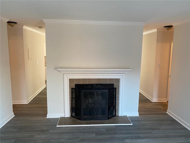 interior details featuring wood-type flooring, crown molding, and a tiled fireplace