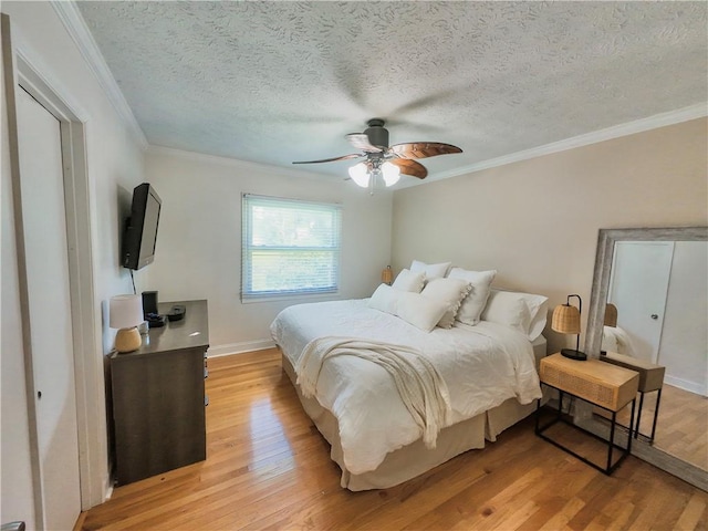 3905 Hunt Dr SE, Gainesville, GA 30507 - bedroom featuring light wood-type flooring, ornamental molding, a textured ceiling, and ceiling fan