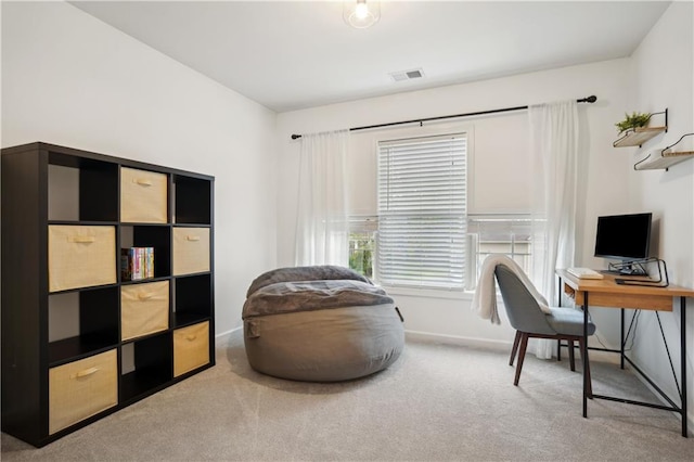carpeted office space with visible vents and baseboards