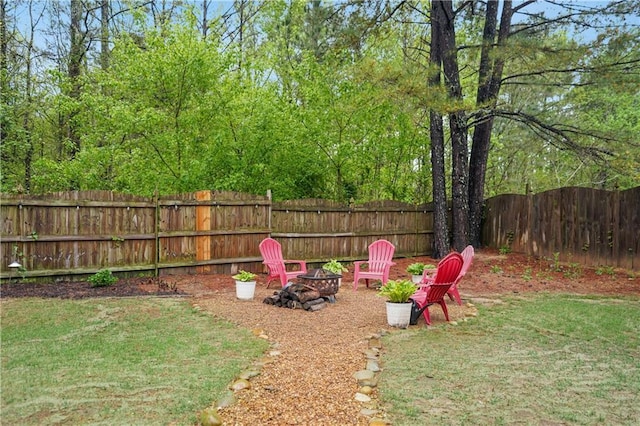 view of yard with an outdoor fire pit and a fenced backyard