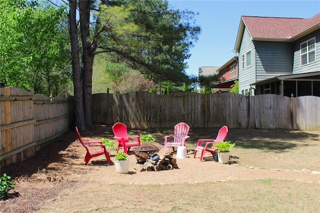 view of yard with a fire pit and a fenced backyard