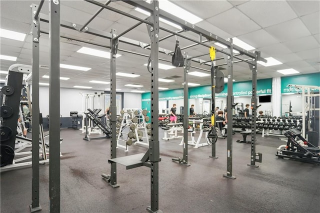 exercise room with a paneled ceiling