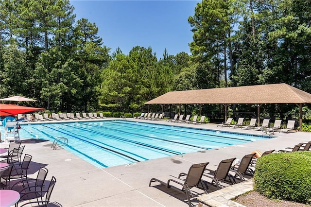 community pool featuring a patio area and fence