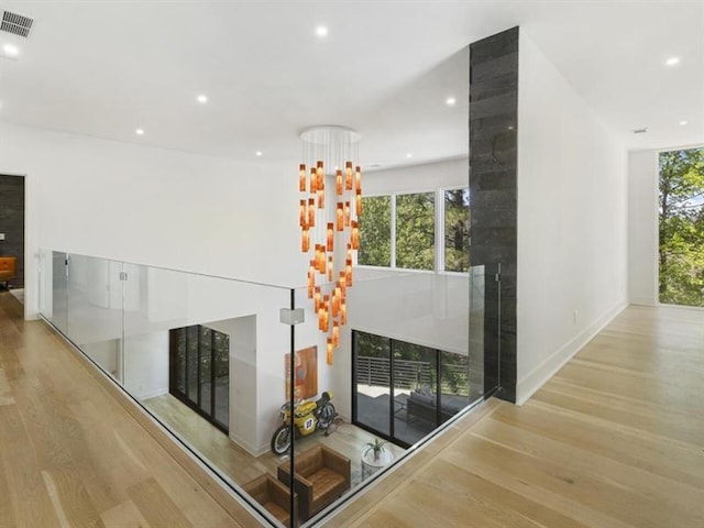 unfurnished living room featuring a healthy amount of sunlight and light hardwood / wood-style flooring