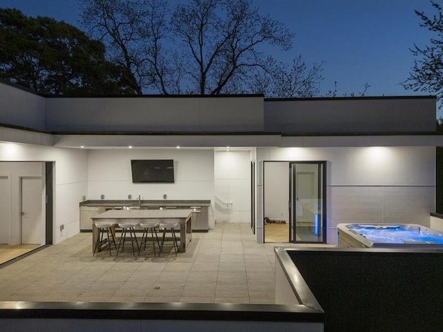 view of patio / terrace with a hot tub