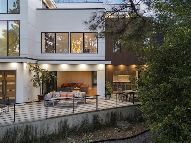 rear view of property featuring outdoor lounge area