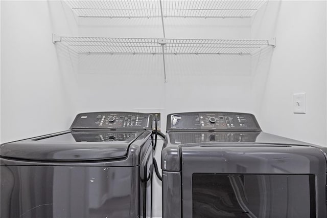 clothes washing area featuring independent washer and dryer