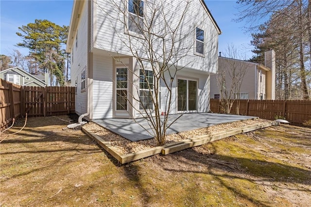 rear view of property with a patio area and a fenced backyard