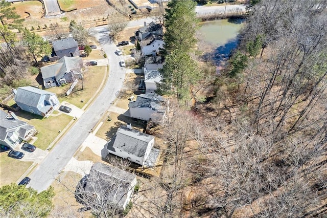 birds eye view of property with a water view and a residential view