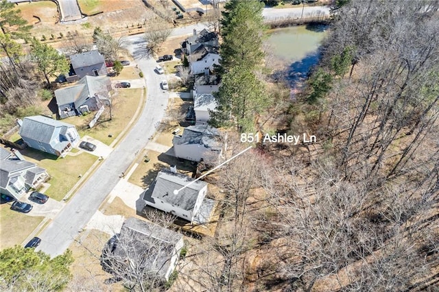 birds eye view of property with a water view and a residential view