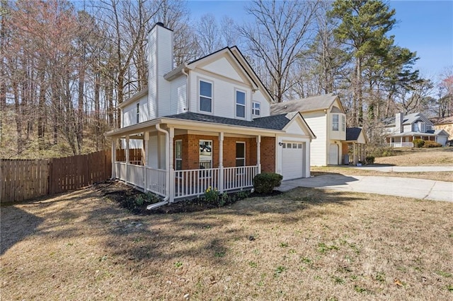 view of front facade featuring a garage, driveway, fence, a porch, and brick siding