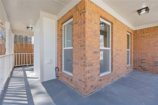 exterior space with covered porch and fence