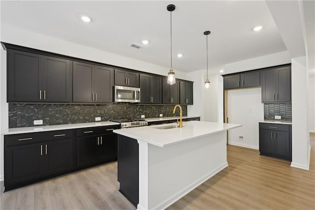 34 Gresham Ct, Dawsonville, GA 30534 - kitchen with a sink, stainless steel microwave, backsplash, light wood-style floors, and recessed lighting