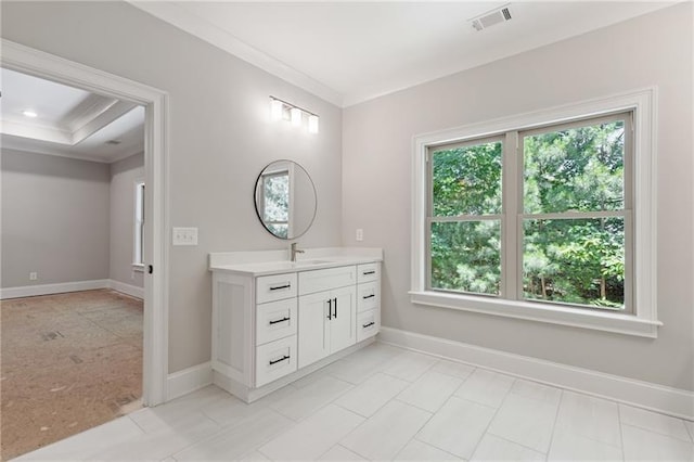 bathroom featuring crown molding, a healthy amount of sunlight, and vanity