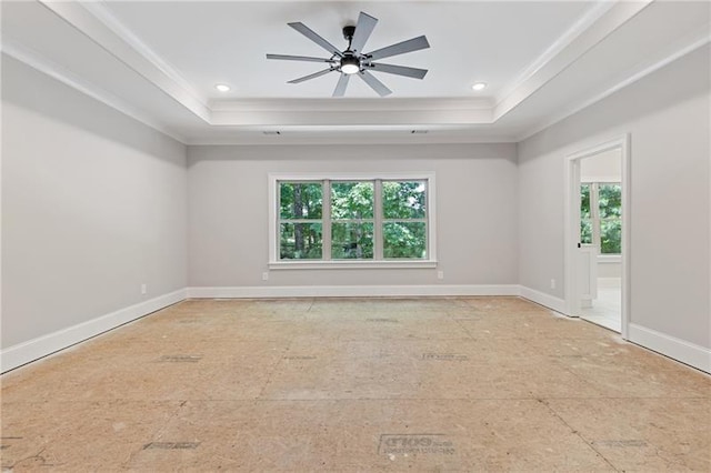 spare room featuring a wealth of natural light, ornamental molding, and a raised ceiling