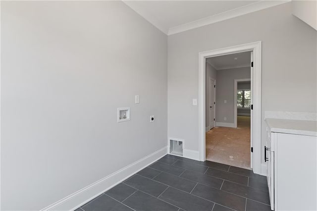 laundry room featuring dark tile patterned floors, crown molding, electric dryer hookup, and washer hookup