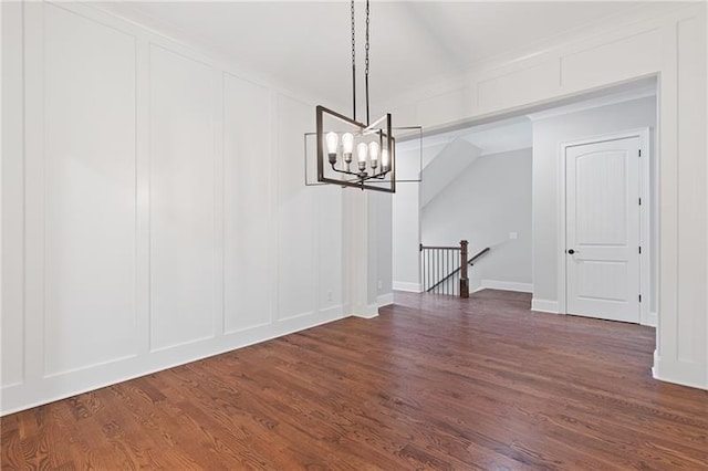 unfurnished dining area featuring dark hardwood / wood-style flooring and a chandelier