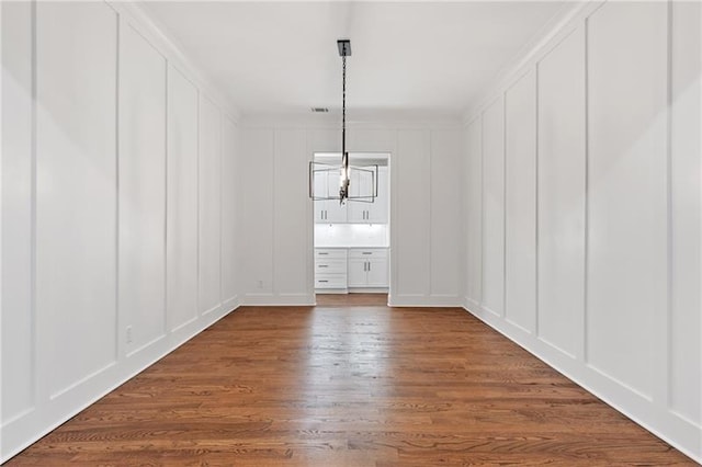 unfurnished dining area featuring dark hardwood / wood-style floors