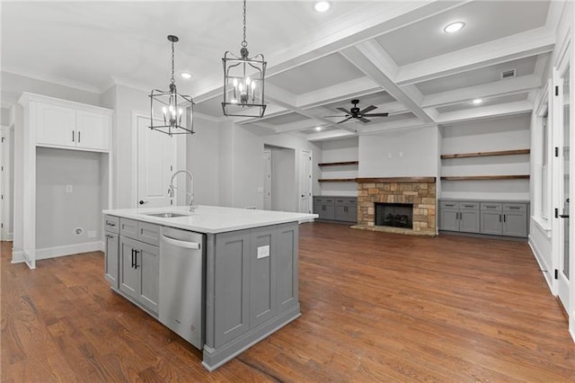 kitchen featuring sink, gray cabinetry, hanging light fixtures, an island with sink, and stainless steel dishwasher