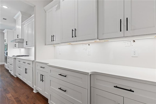 kitchen featuring white cabinetry, dark hardwood / wood-style flooring, and appliances with stainless steel finishes