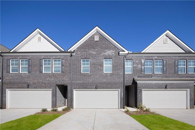 224 Epping St Unit 7, Stockbridge, GA 30281 - townhome / multi-family property featuring an attached garage, driveway, and brick siding