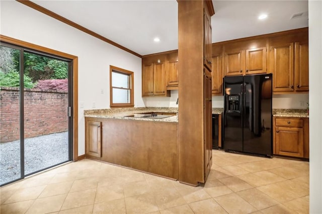 kitchen with light tile patterned flooring, black appliances, and light stone countertops