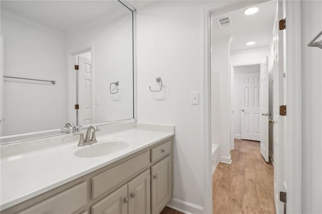 bathroom with vanity and hardwood / wood-style flooring