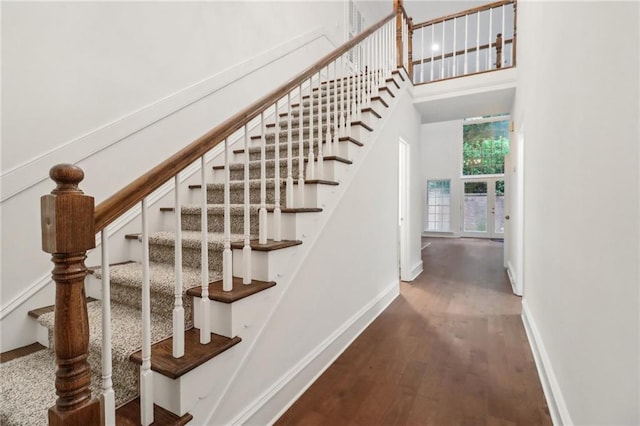 stairs featuring hardwood / wood-style floors