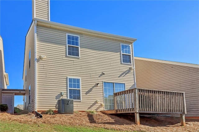 back of property with central AC and a deck