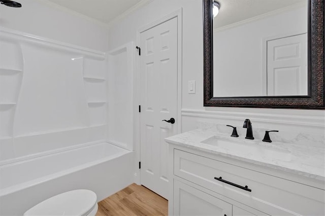 full bathroom with crown molding, wood-type flooring, tub / shower combination, and vanity