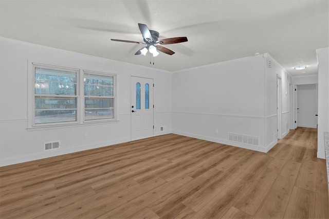 unfurnished room featuring crown molding, light hardwood / wood-style flooring, and ceiling fan