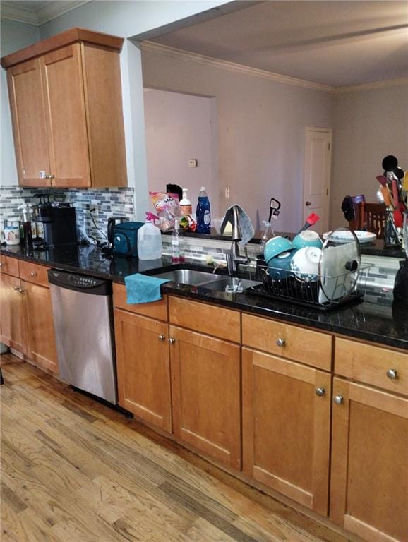 kitchen with sink, light wood-type flooring, ornamental molding, dishwasher, and decorative backsplash