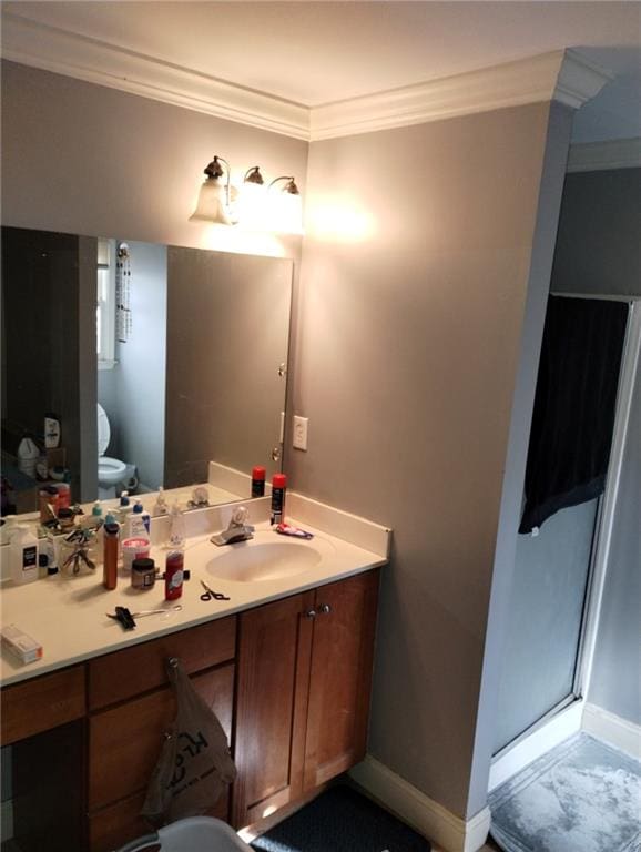 bathroom featuring walk in shower, ornamental molding, toilet, and vanity