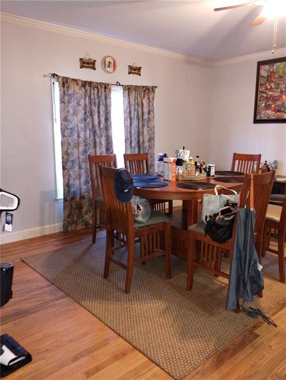 dining room featuring hardwood / wood-style flooring and ornamental molding