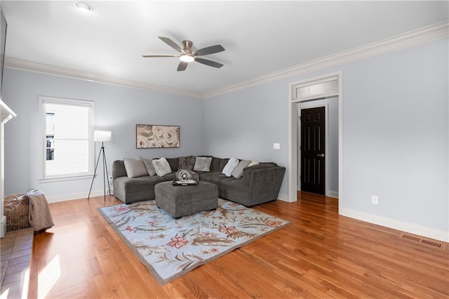 living room featuring visible vents, a ceiling fan, light wood finished floors, and baseboards