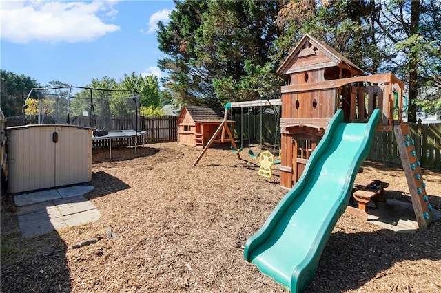 view of jungle gym with a fenced backyard, a storage unit, a trampoline, and an outbuilding