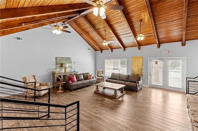 living area with a ceiling fan, visible vents, beam ceiling, wood finished floors, and wooden ceiling